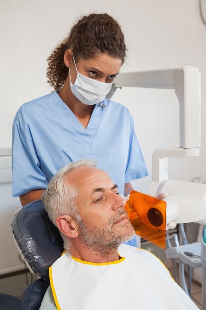 Dentista tomando una radiografía de la boca de los pacientes