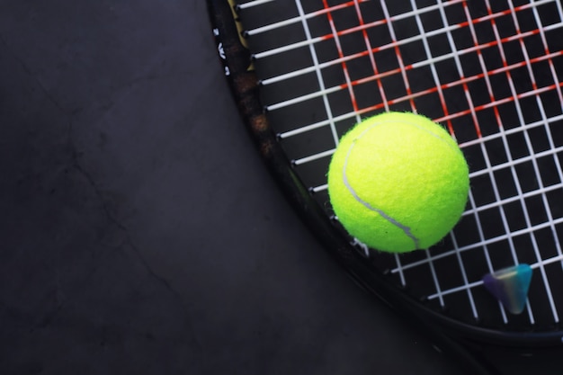 Foto deporte y estilo de vida saludable. tenis. pelota amarilla de tenis y raqueta sobre la mesa. fondo deportivo con concepto de tenis.