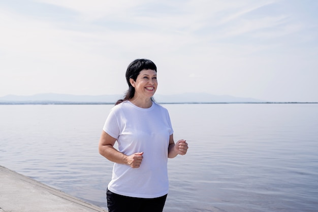 Deporte senior. Mayores activos. Mujer senior activa para correr cerca de la orilla del río