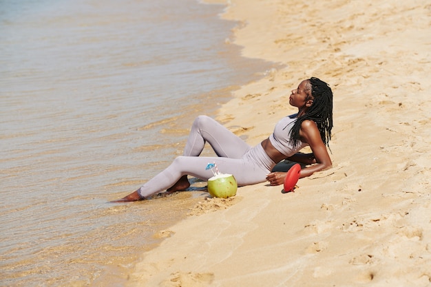 Deportista descansando en la playa