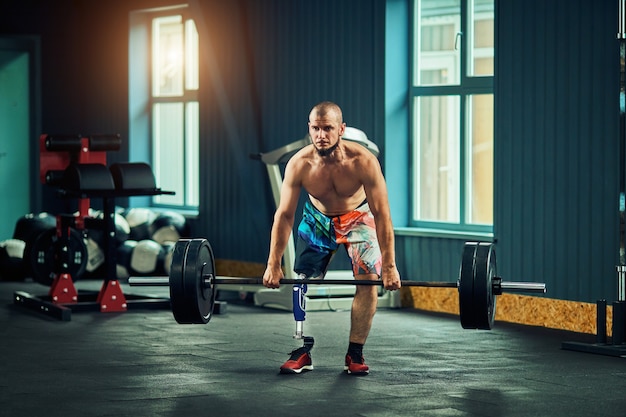 Deportista con prótesis trabajando en gimnasio