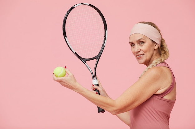 Deportiva mujer madura con raqueta de tenis