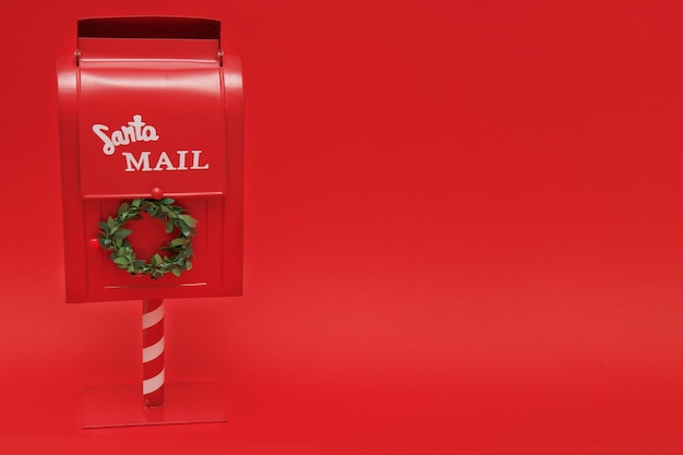 Der Briefkasten des Weihnachtsmanns auf rotem Hintergrund mit Kopierraum
