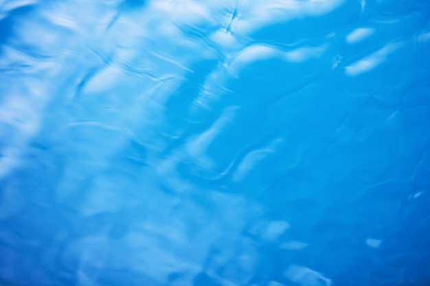 Der glatte natürliche Hintergrund des blauen Wassers mit bokeh Zusammenfassung auf dem Meer