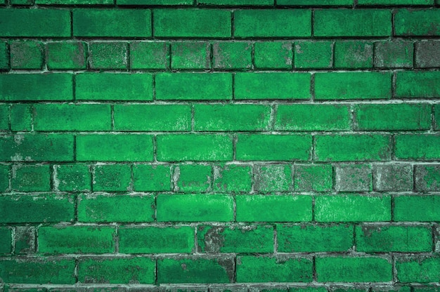 Der grüne Hintergrund der alten Ziegel Bemalte grüne Wand im Grunge-Stil oder Loft-Stil