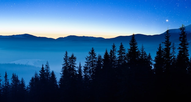 Der herrliche Sternenhimmel befindet sich über der malerischen Aussicht auf das Skigebiet