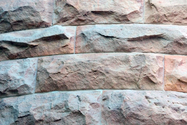Der Hintergrund der Wand des alten Gebäudes, die Fliesen, die Textur des Zauns