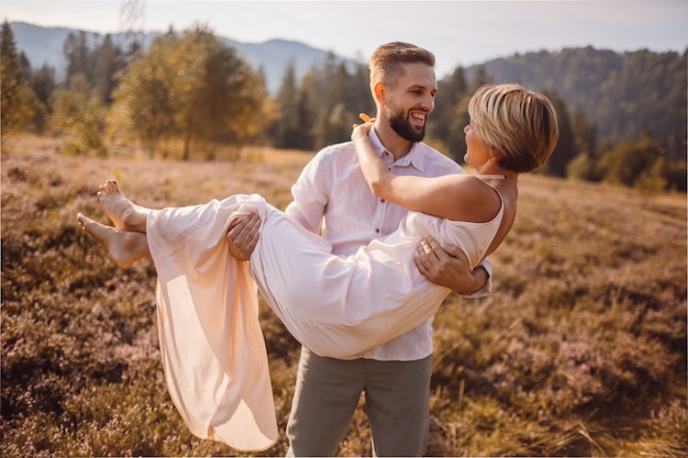 Der Junge hält an Händen sein Mädchen