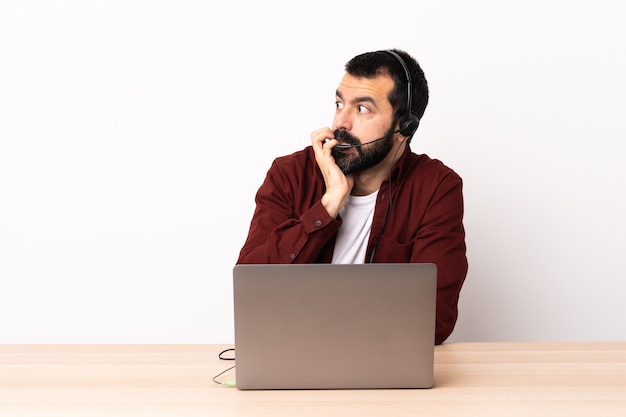 Der kaukasische Telemarketer, der mit einem Headset und einem Laptop arbeitet, ist etwas nervös.