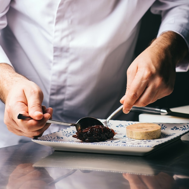 Foto der küchenchef dekoriert einen teller foie gras