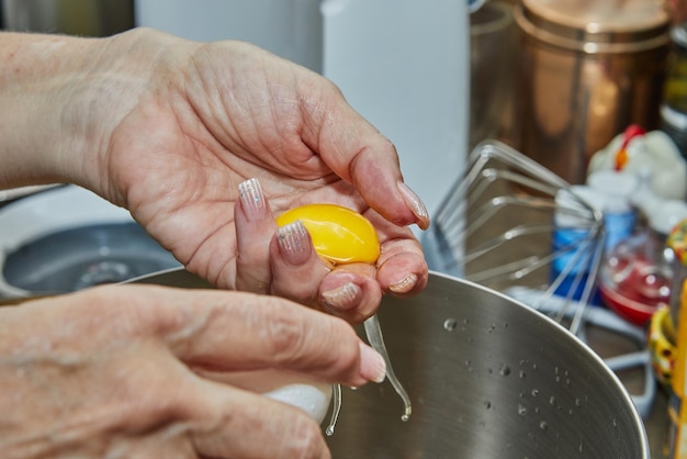 Der Küchenchef trennt das Eigelb vom Protein, um den Kuchen zuzubereiten