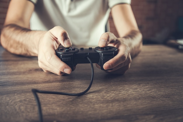 Foto der mann spielt auf der konsole am tisch