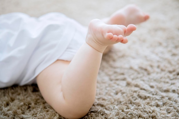Foto der untere teil des auf dem teppich liegenden babys