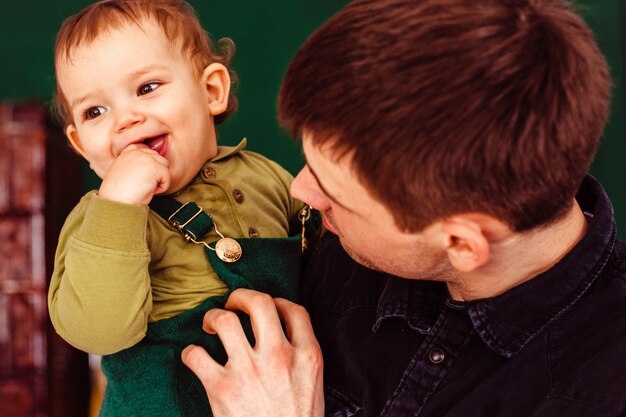 Der Vater hält den Händen an seinem Sohn