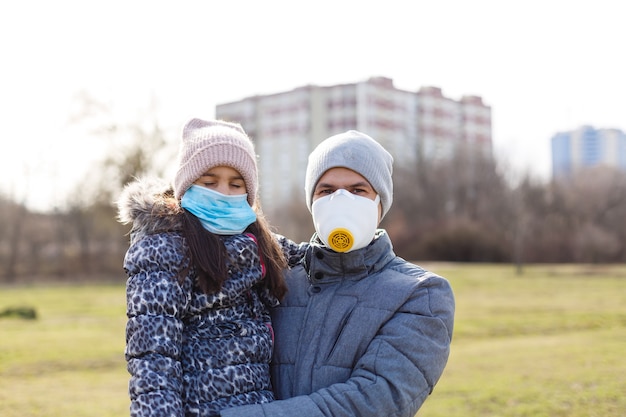 Der Vater trägt seiner kleinen Tochter eine Maske, um das Kind vor Luftverschmutzung und Covid-19 zu schützen, Konzept des Lebensstils der Menschen in der Krise des Krankheitsausbruchs und des Luftproblems.