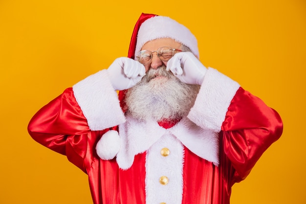 Der Weihnachtsmann weint mit den Händen in den Augen.