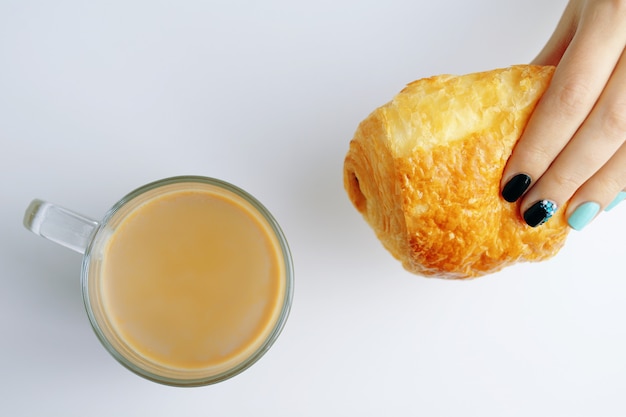 Desayuno con croissant francés y café.