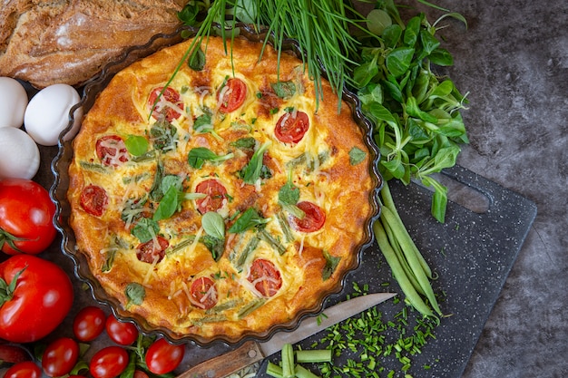 El desayuno del domingo por la mañana. Tortilla al horno con judías verdes, tomates, hierbas y queso.