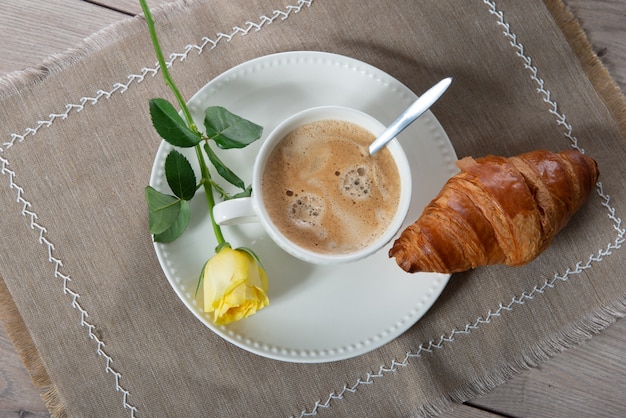 Desayuno francés, café con leche y croissants.