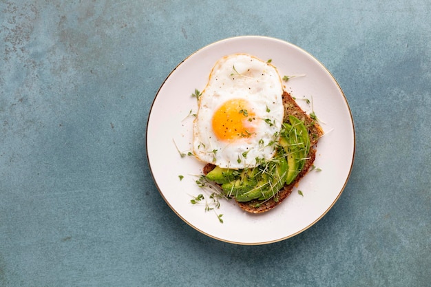 Desayuno Keto huevo frito aguacate y pan en un plato blanco Concepto de dieta Keto