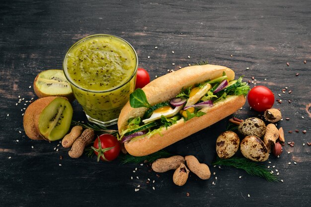 Desayuno Kiwi y queso de hamburguesa con huevos de codorniz y verduras Sobre un fondo de madera Vista superior Espacio de copia