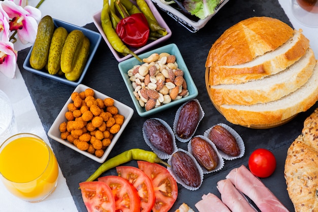 Desayuno en la mesa. El desayuno incluye pan de croissant, cereal de croissant, tocino, jamón, queso, lechuga, frijoles, hojuelas de maíz, fruta, café, té y jugo de naranja. Almuerzo o cena todos los días.