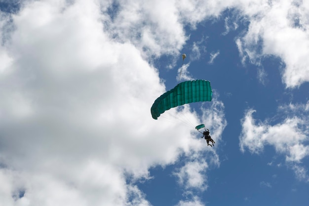 Descenso en paracaídas de dos personas visto desde abajo