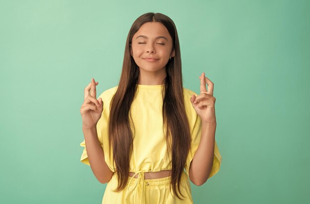 Desejando sorte, criança sorridente, dedos cruzados, beleza e moda, modelo feminino