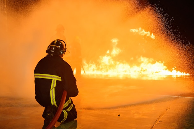 Foto desenfoques y siluetas de bomberos extinguiendo incendios y ayudando a las víctimas.