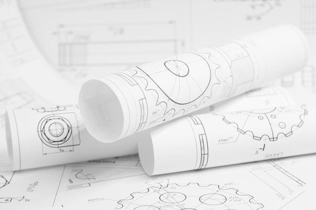 Foto desenhos de engenharia em papel de peças e mecanismos industriais