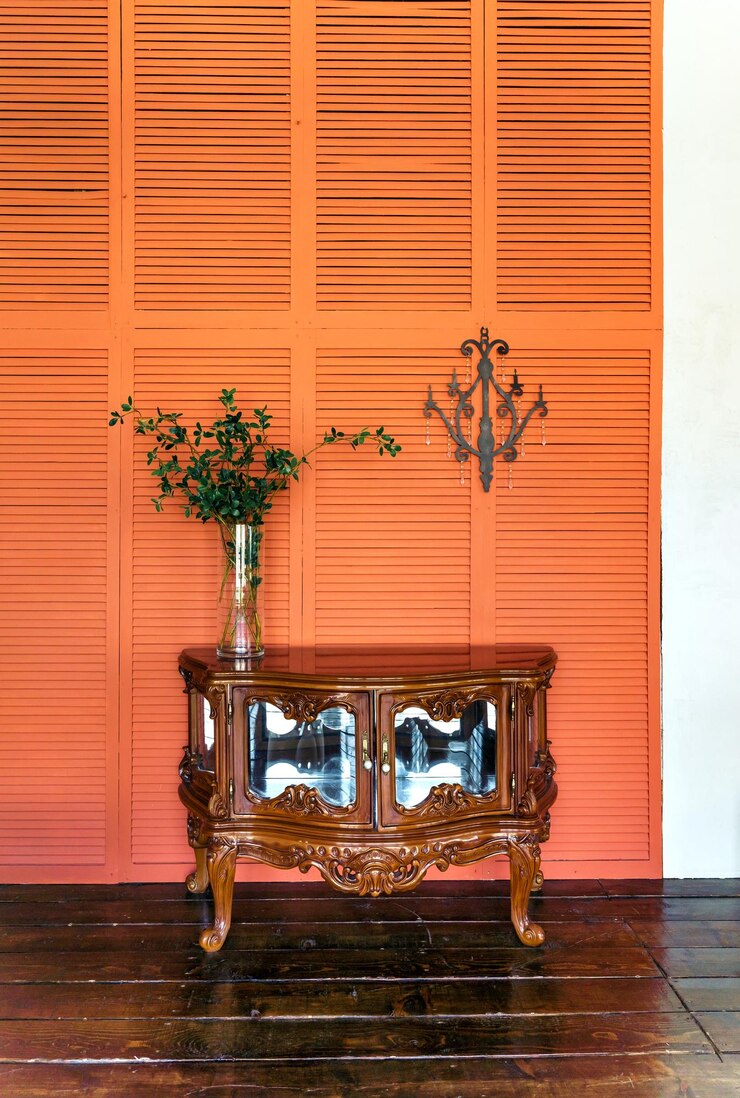 Foto design de interiores elegante da sala de estar com cômoda de madeira retrô paredes laranja ou terracota decoração da casa