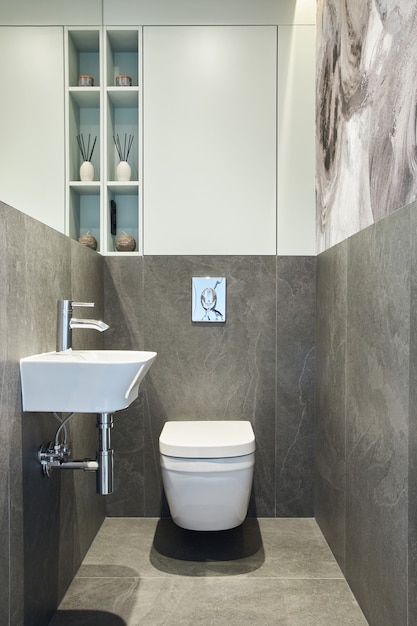 Design interior de banheiro pequeno minimalista, elegante e criativo com paredes de mármore, plantas e belos acessórios de banheiro. Conceito de casa minimalista.