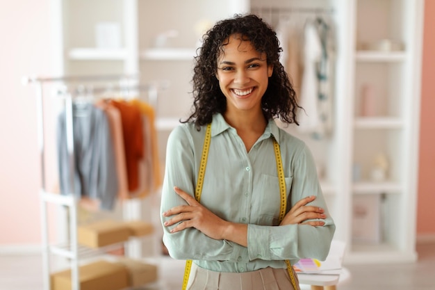 Designer de moda confiante em estúdio com fita métrica