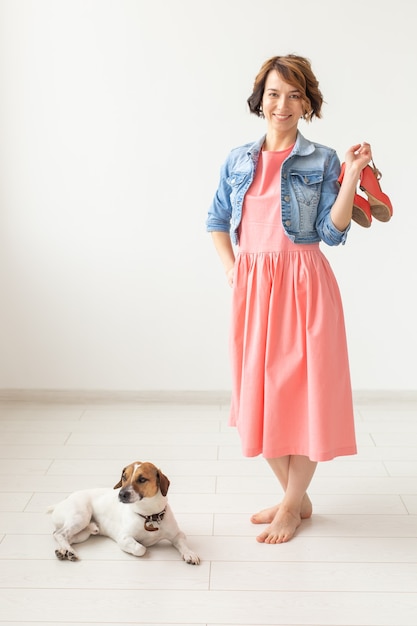 Designer de roupas, pessoas, conceito de animal de estimação, mulher jovem com vestido e jaqueta jeans com jack russell