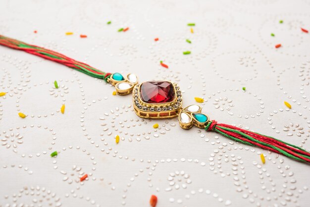 Designer Rakhi/Raakhi oder Armband für das indische Festival Raksha Bandhan, isoliert über dekorativer Oberfläche