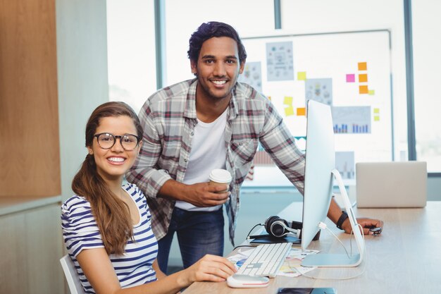 Designers gráficos masculinos e femininos, trabalhando na sala de conferências