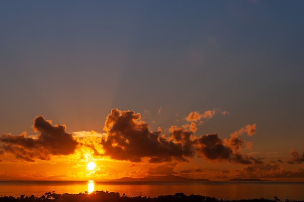 Deslumbrante amanecer detrás de la isla Ishigaki coloridas nubes rayos de sol Vista superior vista desde la isla de Iriomote