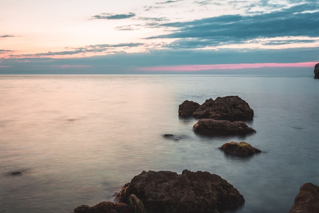 Foto destino de férias brilhante praia nascer do sol e fundo de falésias do mar