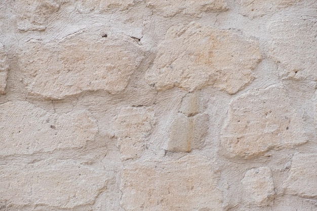 Detaillierter strukturierter Hintergrund aus Sandstein alter Mauer mit hellgelb gefärbten Blöcken