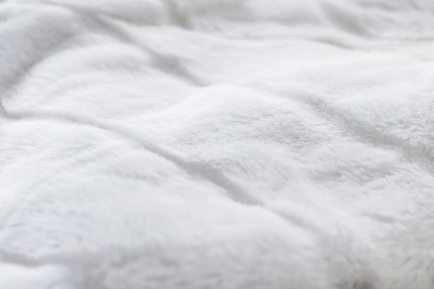 Foto detalhe de tecido artificial de fundo de textura de casaco de pele de luxo branco
