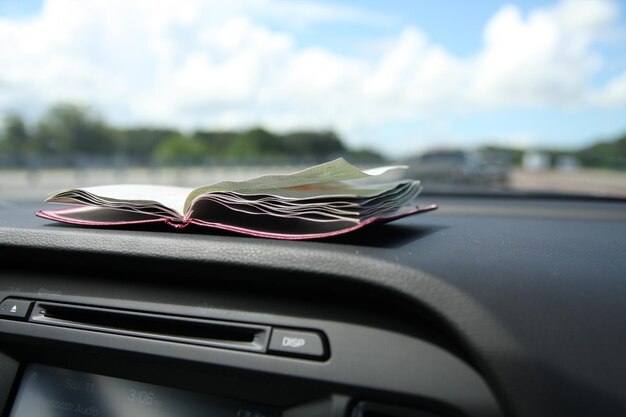 Detalhe de um notebook aberto dentro do carro perto do para-brisa