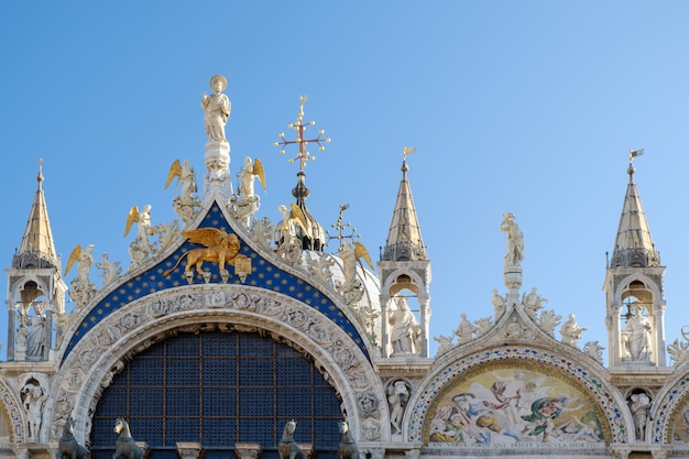 Foto detalhes arquitetônicos da parte superior da fachada da basílica de san marco, em veneza, itália