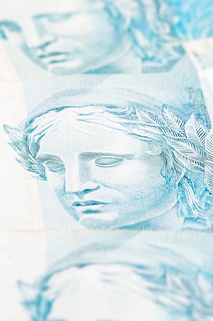 Foto detalhes da nota de 100 reais do brasil com foco seletivo imagem de fundo para o conceito monetário crise financeira ou negócios financeiros no brasil