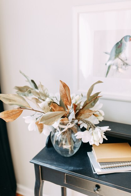 Detalhes luminosos do interior em estilo moderno. vaso e buquê de flores secas na mesa.