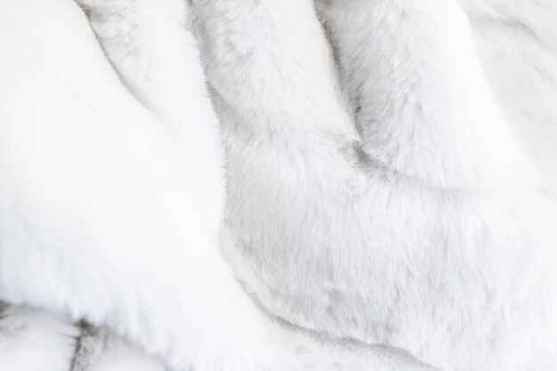 Detalle de tela artificial de fondo de textura de abrigo de piel blanca de lujo