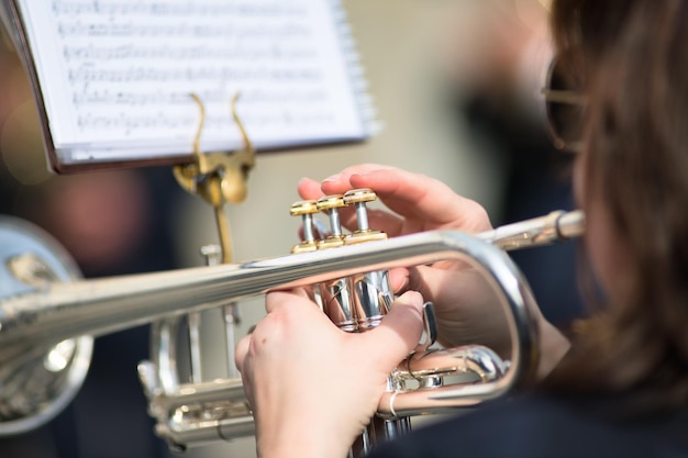 Foto detalles de las manos de la mujer tocando la trompeta