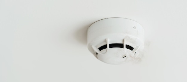 Detector de sensor de humo montado en el techo de una casa o apartamento Concepto de seguridad y seguridad contra incendios