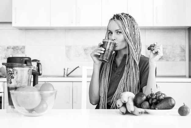 Detox mano femenina sosteniendo un vaso de batido verde orgánico fresco con espinacas fitness y dieta org