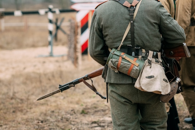 Detrás del soldado Wehrmacht en uniforme y con un rifle