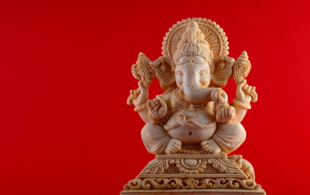 Deus Hindu Ganesha. Ídolo de Ganesha em fundo vermelho